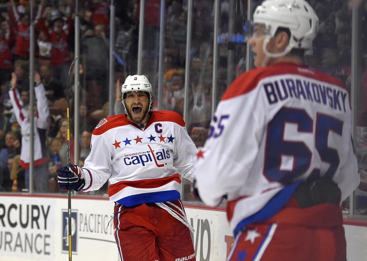 Alex Ovechkin celebrates a goal he assisted that Andre Burakovsky scored. Both Capitals forwards scored a pair of goals.