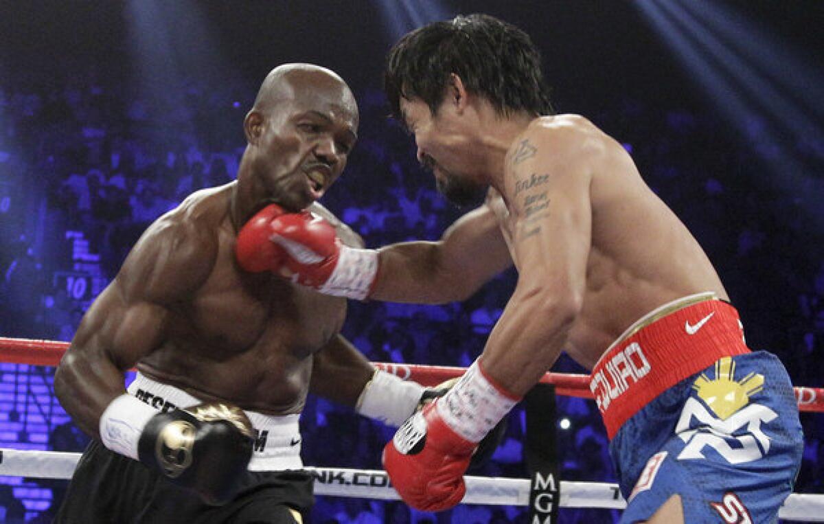 Timothy Bradley absorbs a right to the chin from Manny Pacquiao during their fight in Las Vegas. Bradley won a split decision.