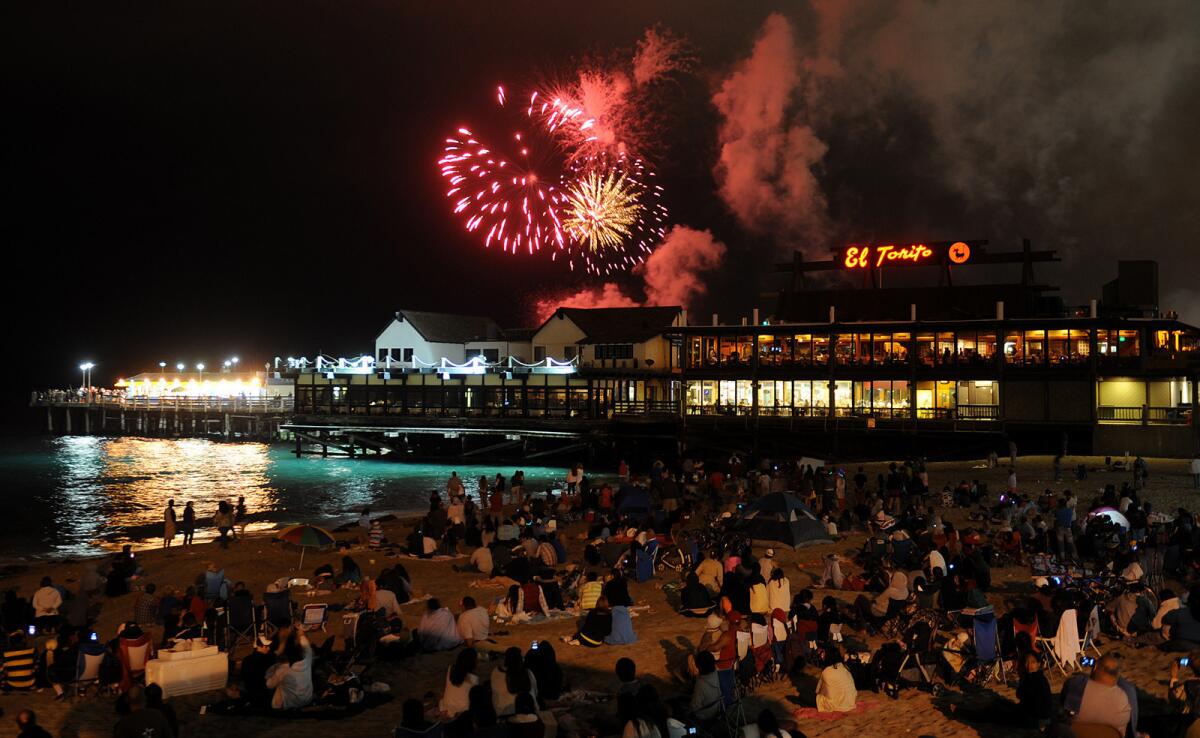 Fireworks lit up the sky over the Redondo Beach Pier last year; there will be more across the region tonight.