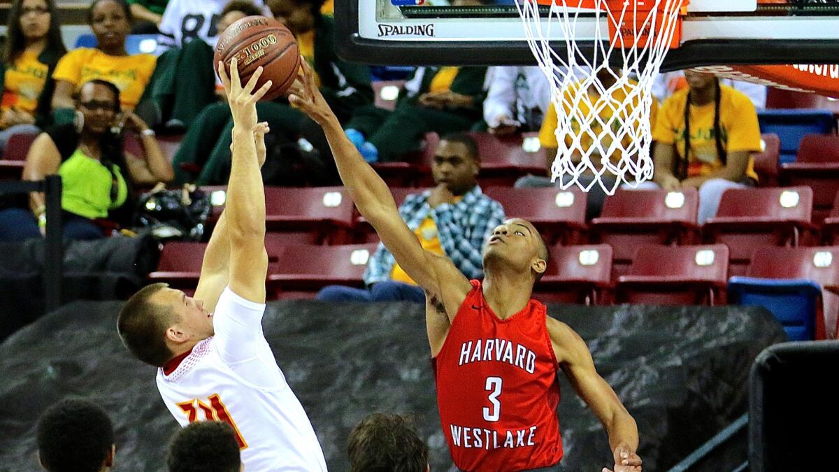 Harvard-Westlake freshman Cassius Stanley (3) rejects a shot by Palma's Liam McMillin in the second quarter of the Division IV state championship game on Saturday at Sleep Train Arena in Sacramento.