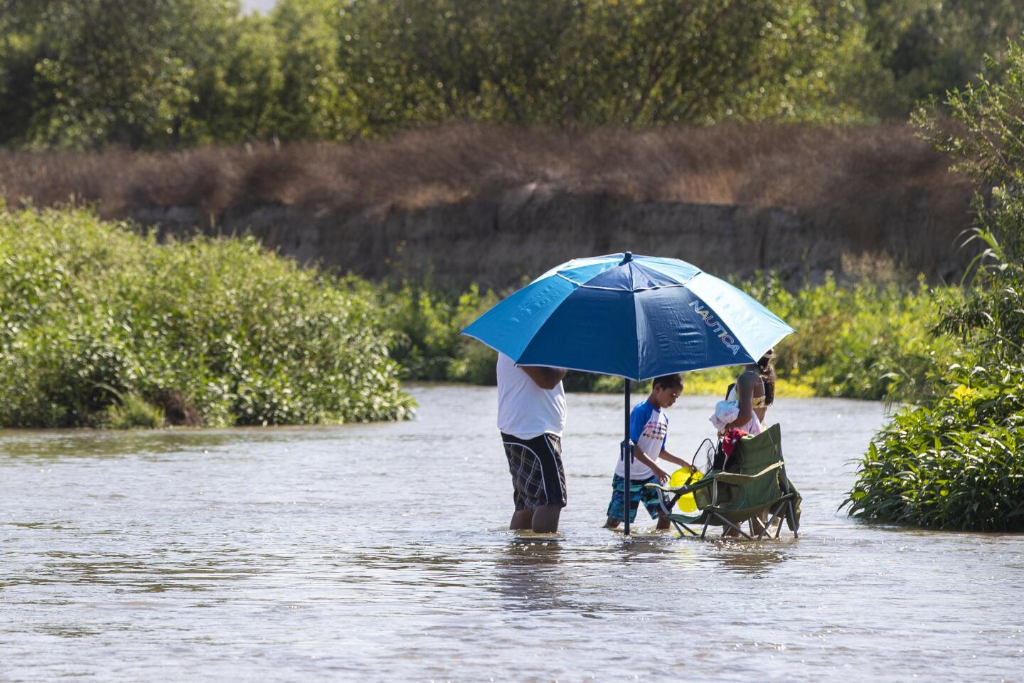 A family cools off in the Santa Ana river
