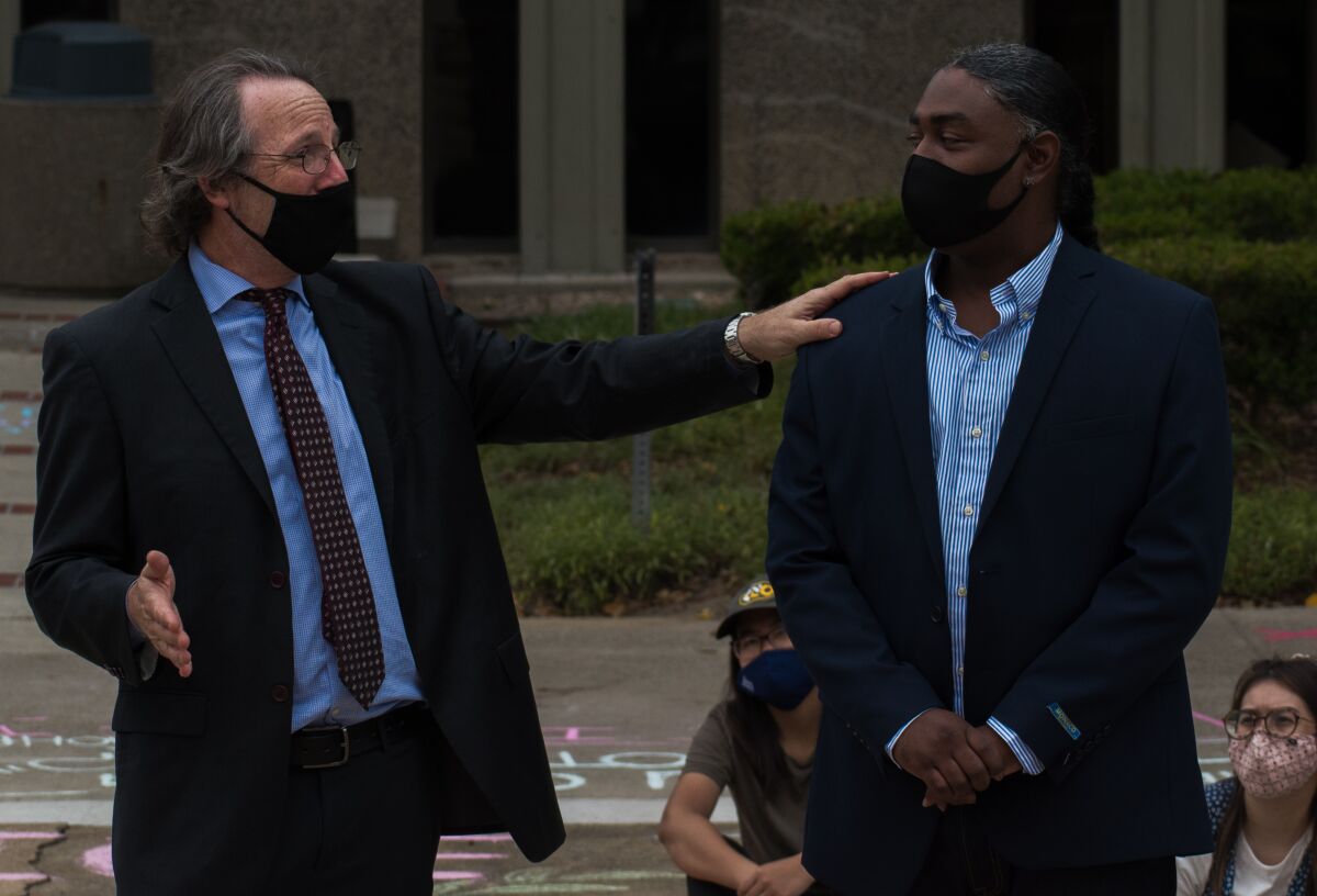 Assistant Public Defender Scott Sanders, left, and Mohamed Sayem stand outside the courthouse. 