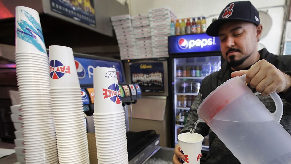 A man fills a disposable cup with water in Berkeley, Calif. on Jan. 23.