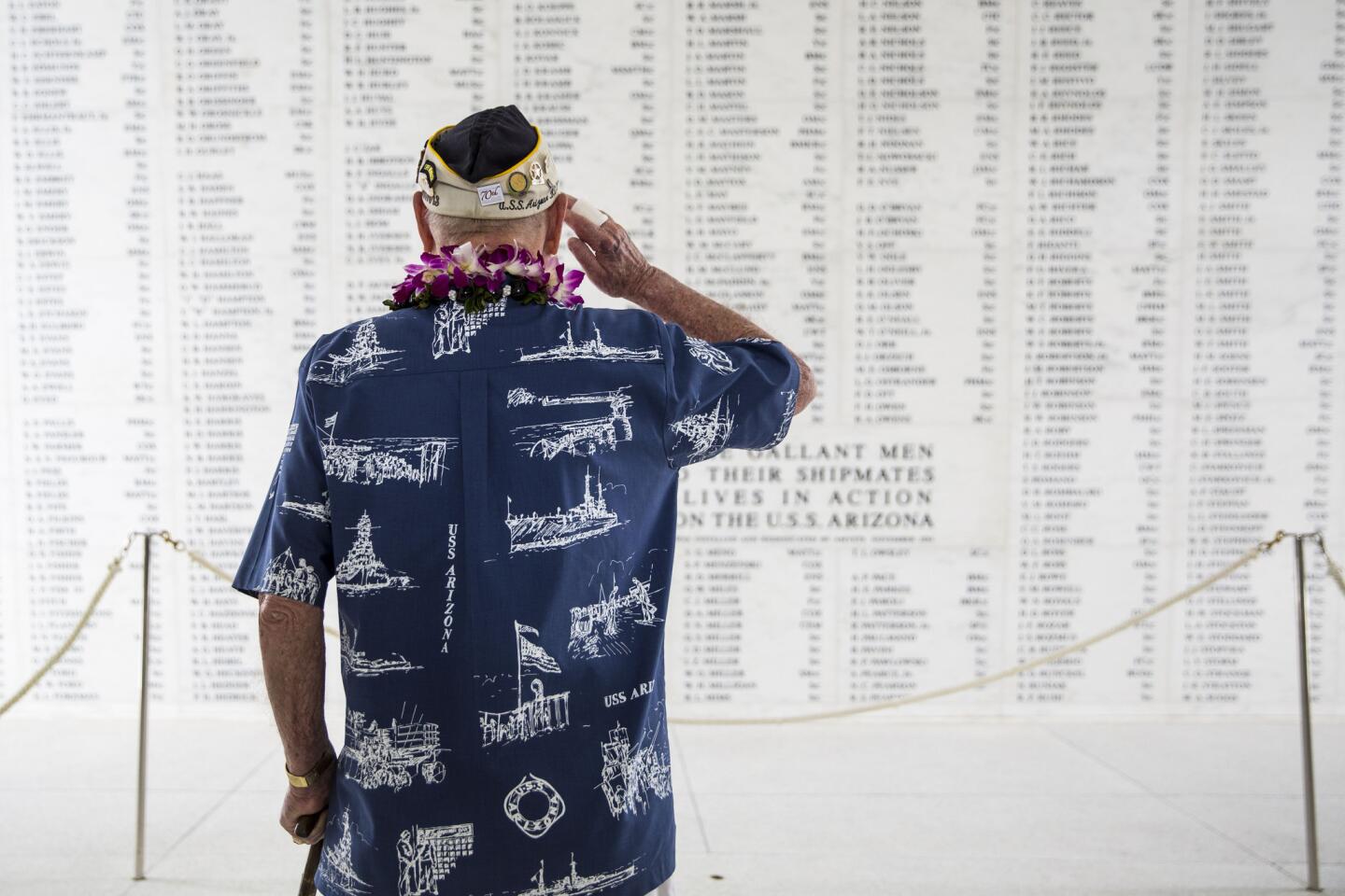 U.S.S. Arizona survivor Lou Conter salutes the Arizona Remembrance Wall during a memorial service marking the 74th Anniversary of the attack on the U.S. naval base at Pearl Harbor Dec. 7, 2015 on the island of Oahu at the Kilo Pier, Joint Base Pearl Harbor-Hickam, in Honolulu, Hawaii. (Photo by Kent Nishimura/Getty Images)