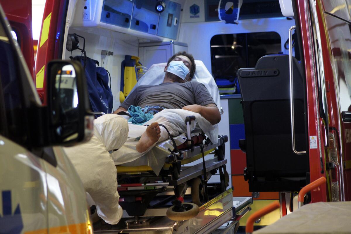 A man lies in an ambulance