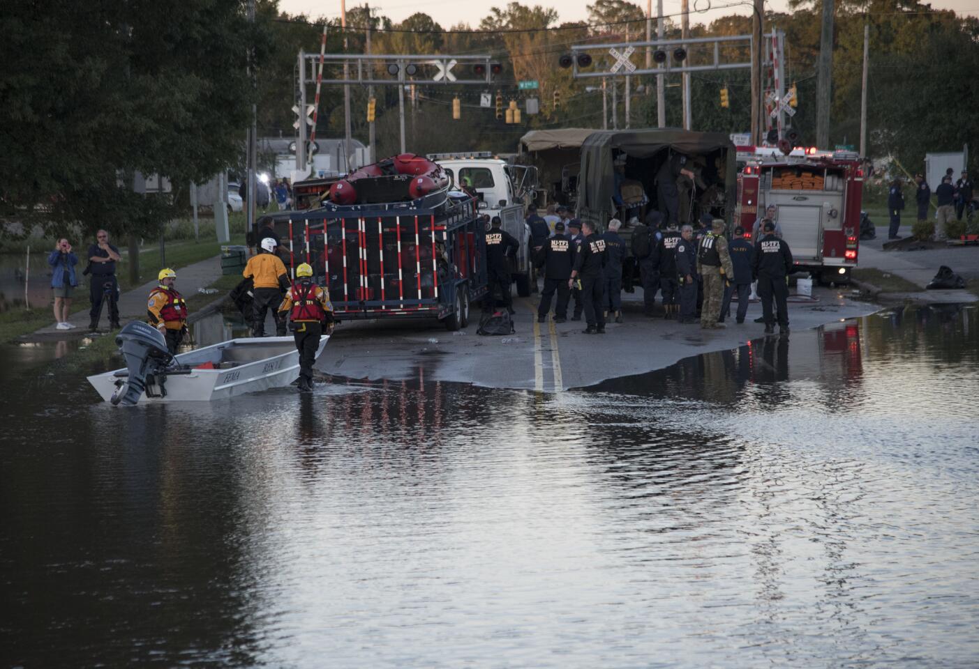 Swift water rescue teams stage at the foot of Martin Luther King Jr. Drive as part of the rescue efforts from floodwaters caused by rain from Hurricane Matthew in Lumberton, North Carolina, on Oct. 10, 2016.