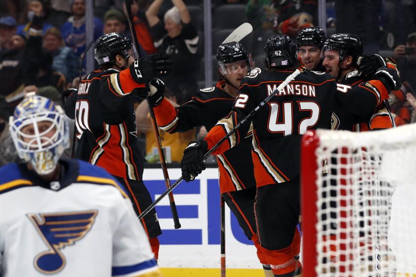 Anaheim Ducks center Sam Carrick, right, celebrates scoring against St. Louis Blues goaltender Jordan Binnington.
