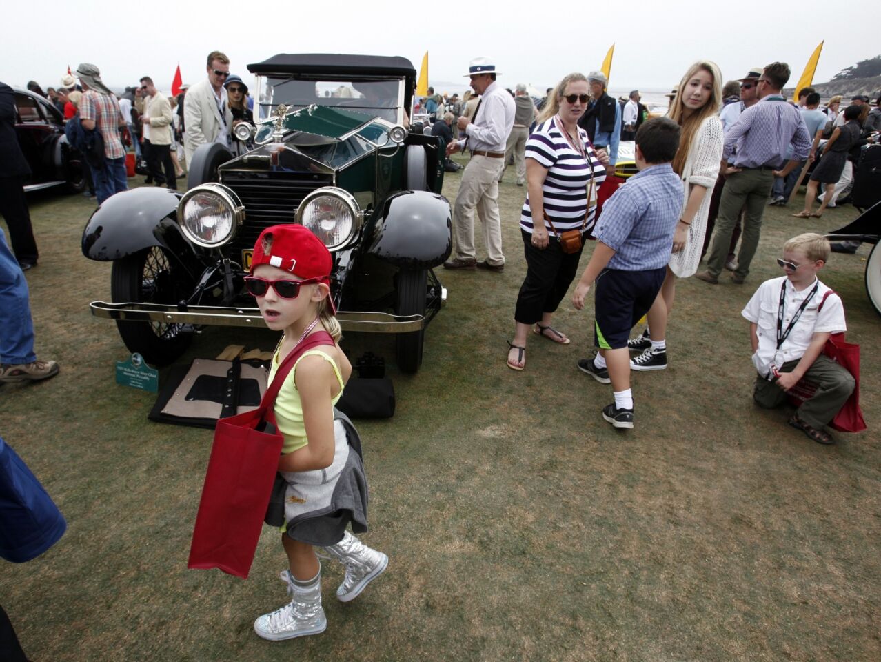 Julia Binke, 6, walks in front of a 1925 Rolls-Royce Silver Ghost at the Concours d'Elegance on Sunday.