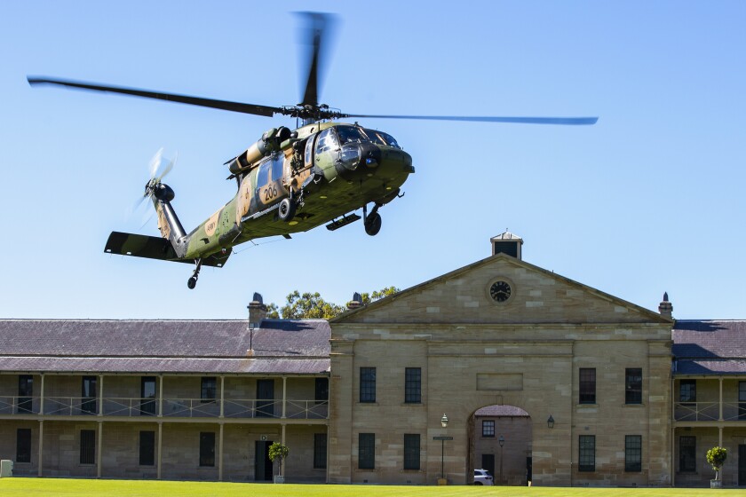 In this photo released by the Australian Department of Defence, an Australian Army S-70A-9 Black Hawk helicopter lands at Victoria Barracks in Sydney, Australia, Friday, Dec. 10, 2021. Australia's military said Friday, Dec. 10, 2021, it plans to ditch its fleet of European-designed Taipan helicopters and instead buy U.S. Black Hawks and Seahawks choppers because the American machines are more reliable. (Cpl. Dustin Anderson/Department of Defence via AP)