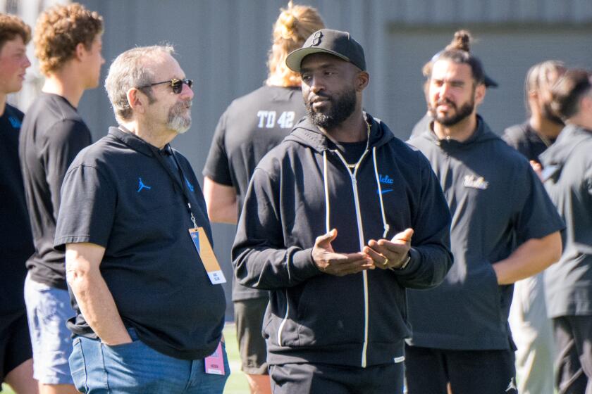 UCLA head coach Deshaun Foster talks on the sidelines during UCLA's pro day