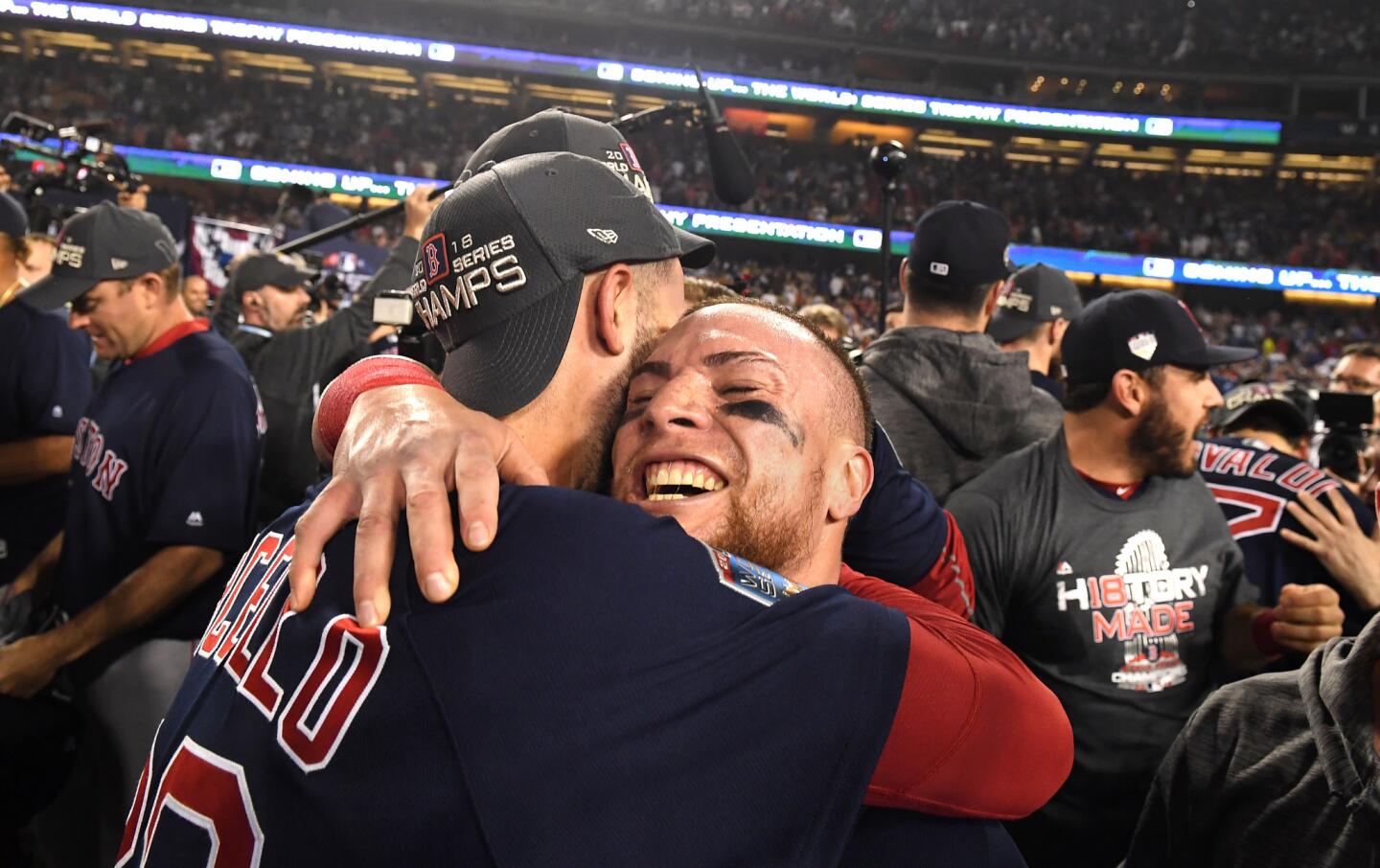 Red Sox pitcher Rick Porcello, left, and catcher Christian Vaszuez hug after winning the championship.