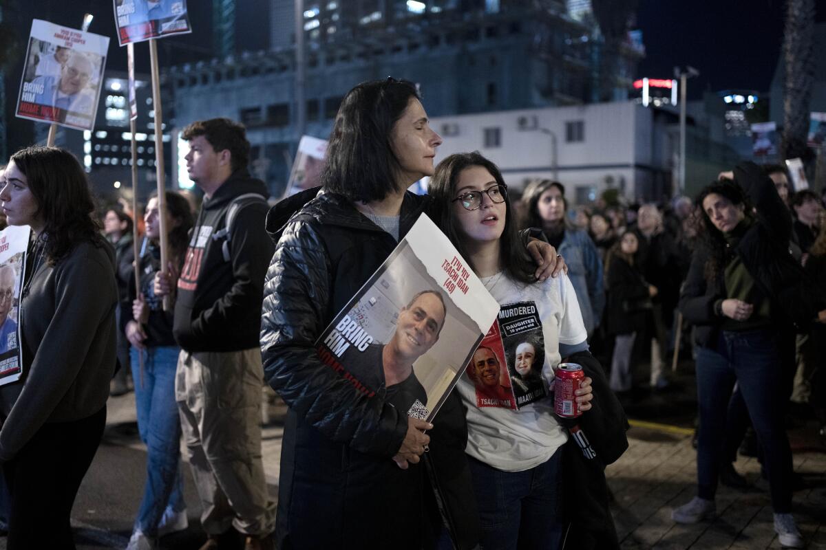 Women listen to a speaker during a rally in Tel Aviv calling for the release of hostages who were kidnapped Oct. 7 by Hamas.