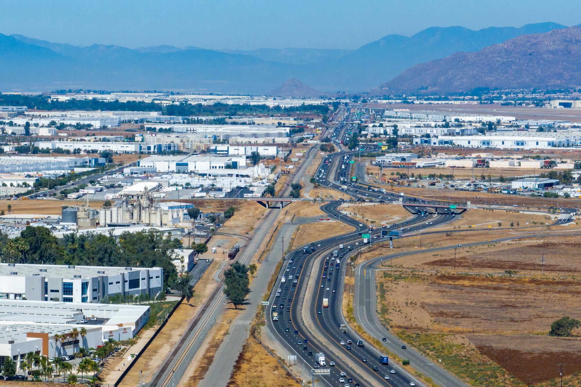 Warehouses line both sides of Interstate 215 in Riverside County.