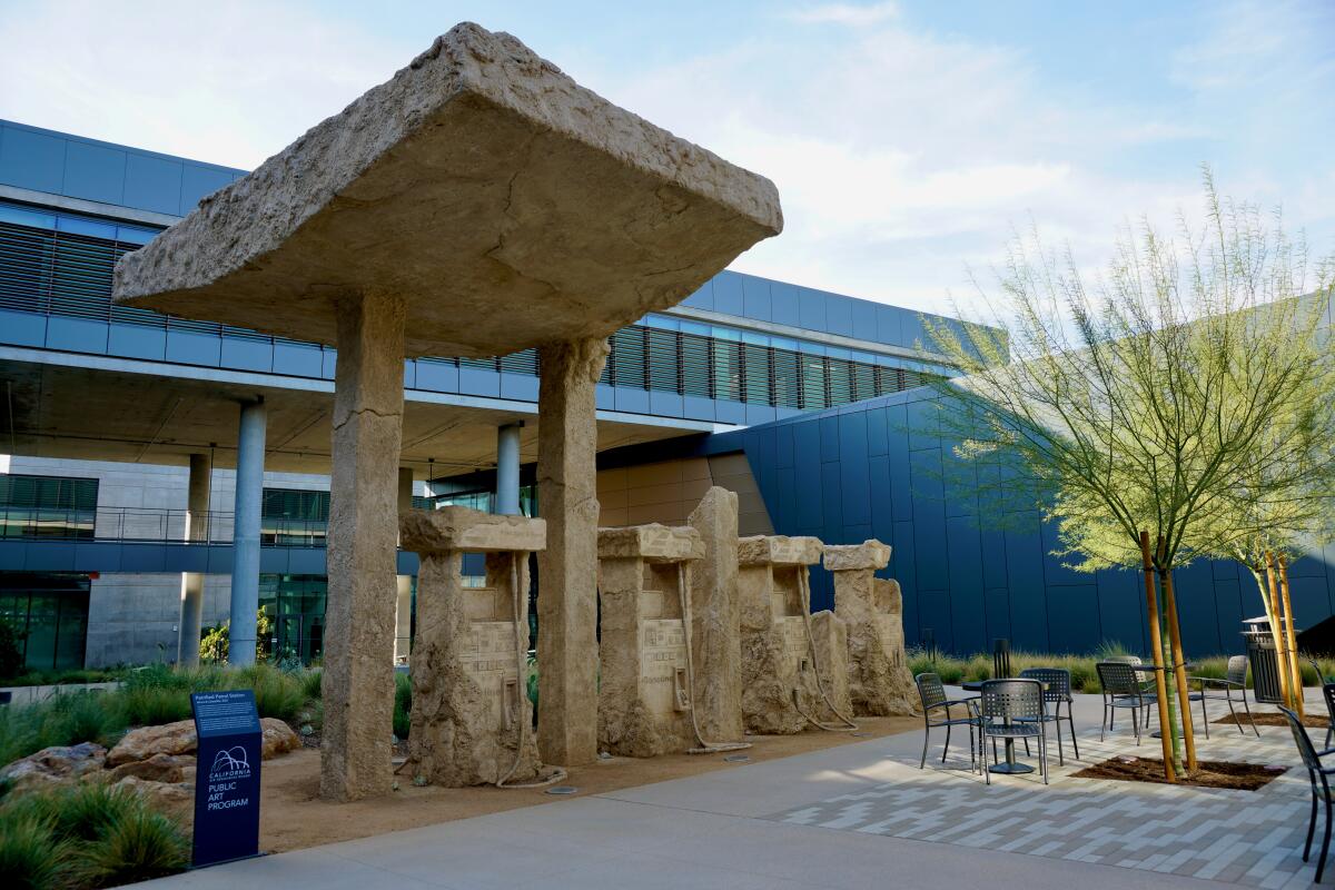 A sculpture resembles stone gasoline pumps.