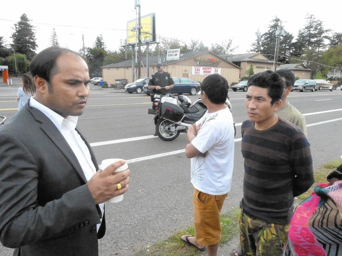 Som Subedi, left, asks fellow Bhutanese immigrant Ash Monger about a car accident Monger witnessed in Portland, Ore., involving another refugee from the mountain nation.