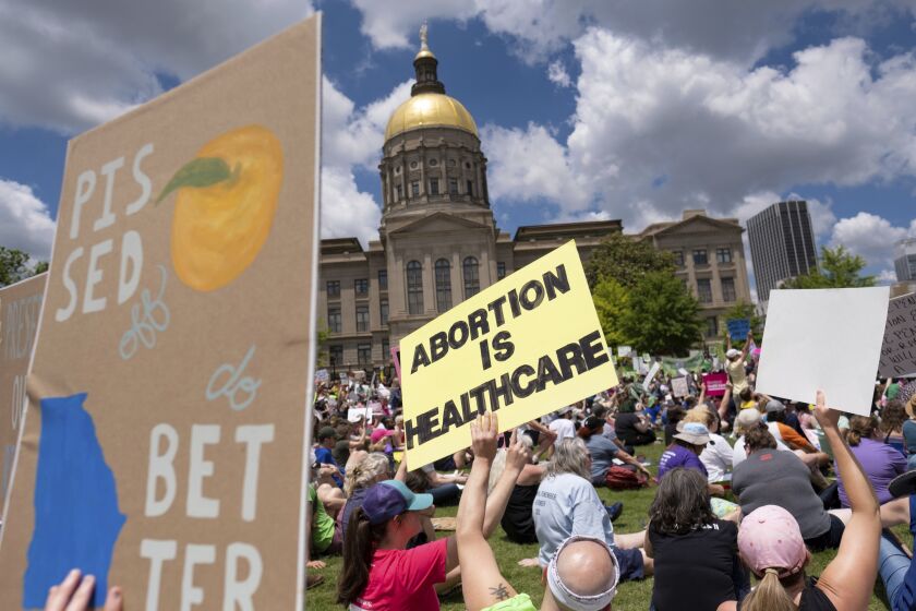 FILE - Abortion rights protesters rally near the Georgia state Capitol in Atlanta on May 14, 2022. Georgia's highest court is considering whether the state's restrictive abortion law is void because it violated U.S. Supreme Court precedent that was in effect at the time when it was enacted. (Ben Gray/Atlanta Journal-Constitution via AP, File)