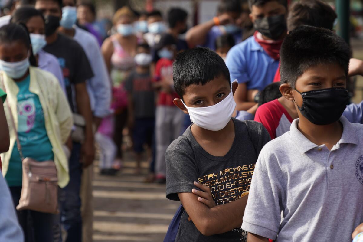 Children and adults at a camp for migrants in Reynosa, Mexico