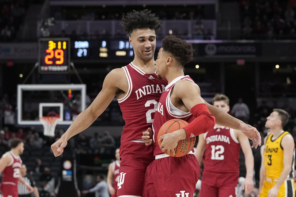 Indiana's Trayce Jackson-Davis (23) reacts with Rob Phinisee during the first half of an NCAA college basketball game against Iowa in the semifinal round at the Big Ten Conference tournament, Saturday, March 12, 2022, in Indianapolis. (AP Photo/Darron Cummings)