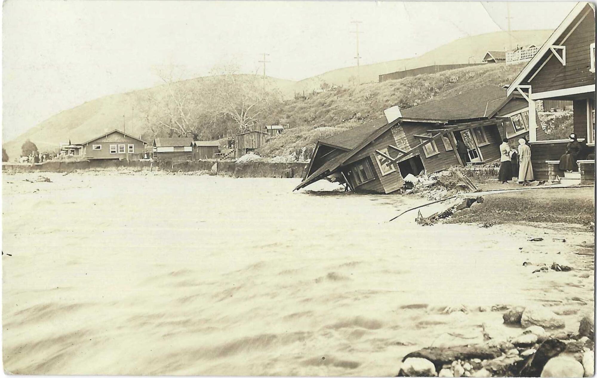 Floodwaters and damaged home. On the back of the card, someone wrote: "The Flood. Sycamore Park, Highland Park, April 1913."