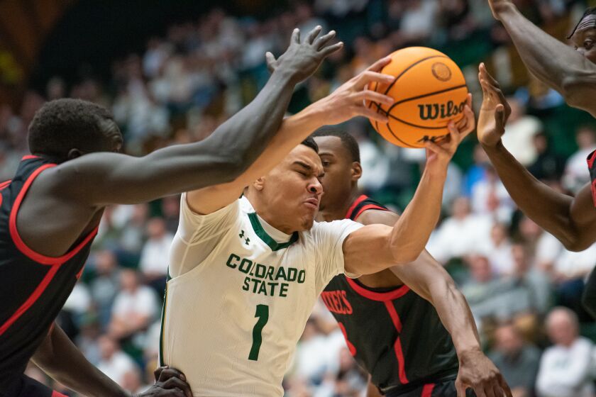 Colorado State University senior guard John Tonje works around San Diego State defenders in a game at CSU's Moby Arena, Wednesday, January 18, 2023, in Fort Collins, Colo.