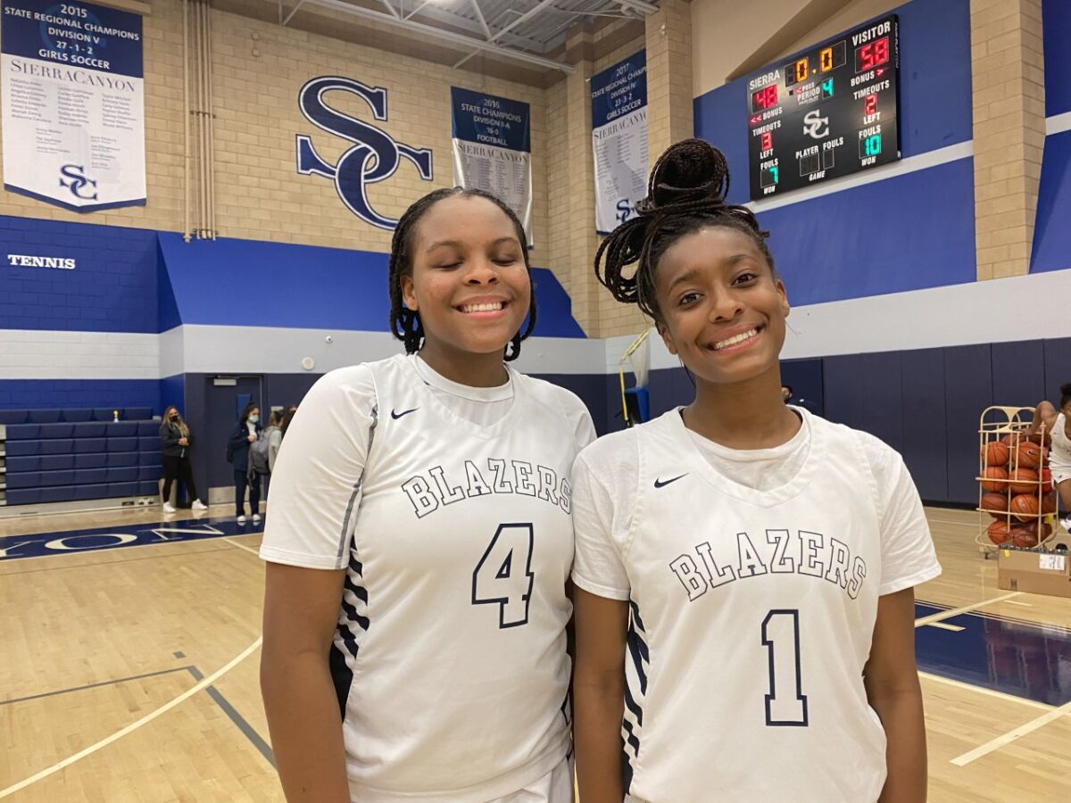 Sierra Canyon's MacKenly Randolph, left, and Izela Arenas stand next to each other and smile.