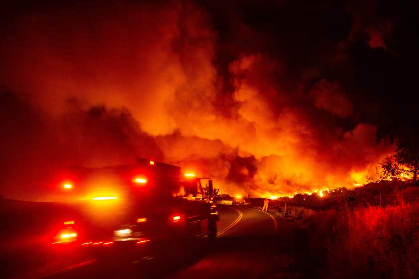 TOPSHOT - A fire truck heads towards flames during the Kincade fire near Geyserville, California on October 24, 2019. - The fire broke out in spite of rolling blackouts by utility companies in both northern and Southern California. (Photo by Josh Edelson / AFP) (Photo by JOSH EDELSON/AFP via Getty Images) ** OUTS - ELSENT, FPG, CM - OUTS * NM, PH, VA if sourced by CT, LA or MoD **