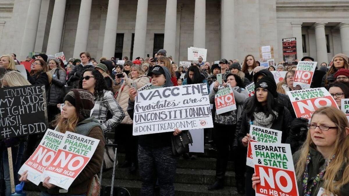 People rally against a proposed state bill that would remove parents' ability to claim a philosophical exemption to opt their school-age children out of the measles, mumps and rubella vaccine, on Feb. 8 in Olympia, Wash.