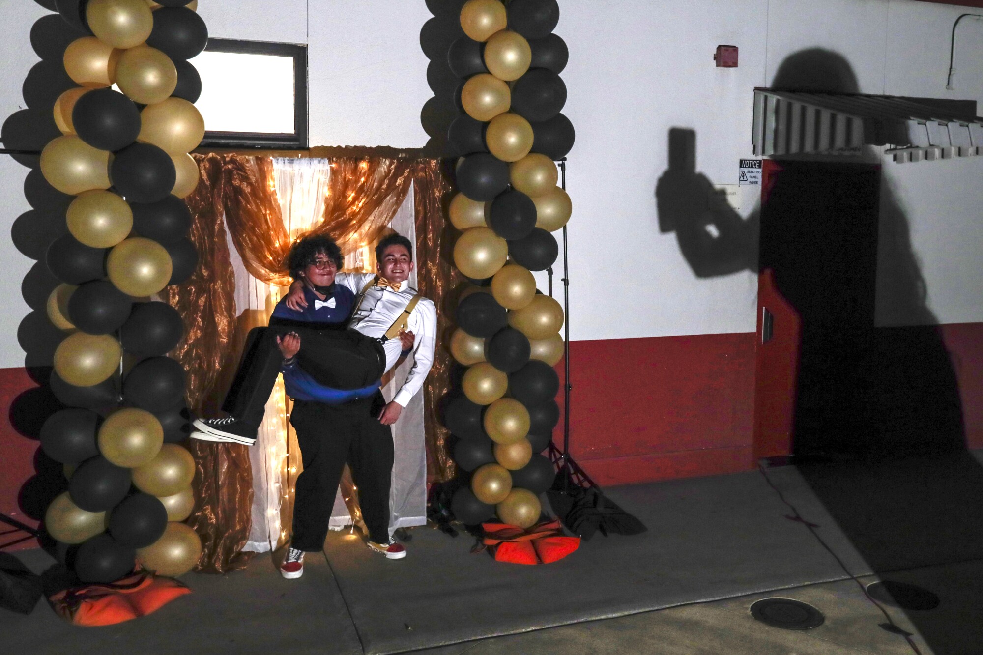 Jesus Medina hoists Jose Gonzalez for a photo taken by Jade Magallanes (shadow) at Sierra Vista High School 