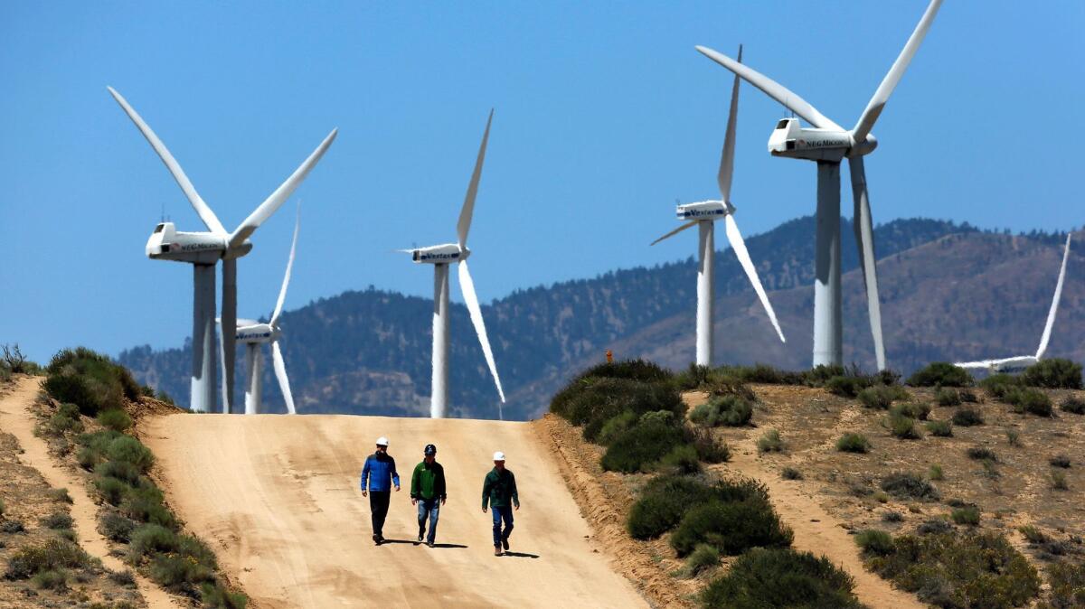 Gregory Wetstone, left, Randy Hoyle and Kevin Martin of Terra-Gen Power at section Alta East wind energy project in the Tehachapi Mountains.