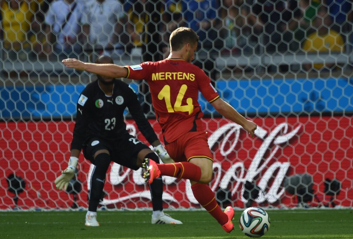 Belgium forward Dries Mertens scores against Algeria goalkeeper Rais Mbohli during a Group H World Cup match Tuesday at the Mineirao Stadium in Belo Horizonte, Brazil.