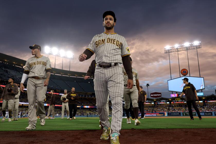 LOS ANGELES, CALIFORNIA - SEPTEMBER 11: Trent Grisham #1 of the San Diego Padres walks back to the dugout before the game against the Los Angeles Dodgers at Dodger Stadium on September 11, 2023 in Los Angeles, California. (Photo by Harry How/Getty Images)