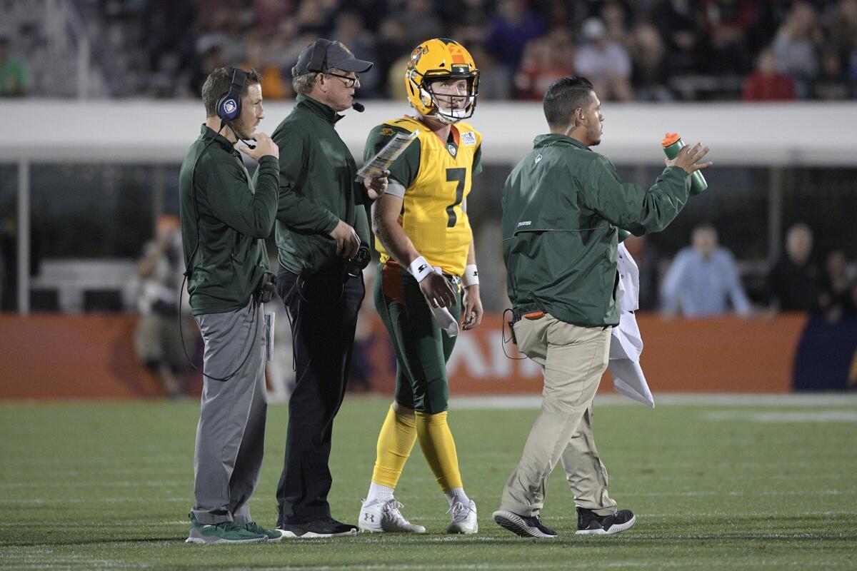 Arizona Hotshots coach Rick Neuheisel, center, talks with quarterback John Wolford.