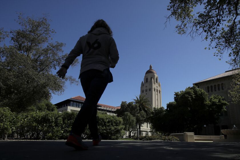In this April 9, 2019 photo, Hoover Tower is shown at rear on the campus at Stanford University in Stanford, Calif. (AP Photo/Jeff Chiu)