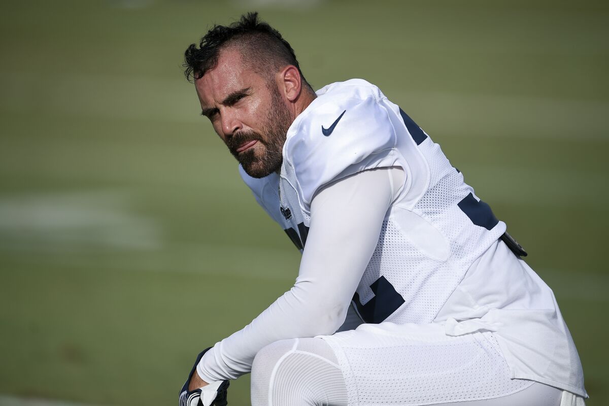 Rams safety Eric Weddle kneels on the practice field.