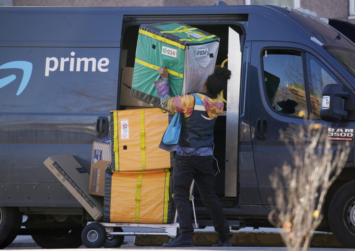 An Amazon Prime delivery person struggles with packages 