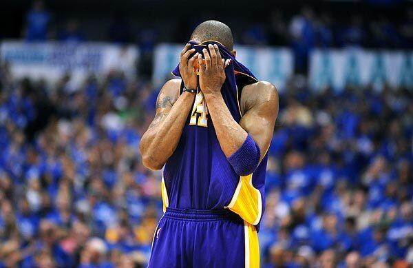 Lakers guard Kobe Bryant wipes his face as he prepares for the final minutes of Game 3 on Friday night in Dallas. Bryant finished with 17 points in the 98-92 loss to the Mavericks.