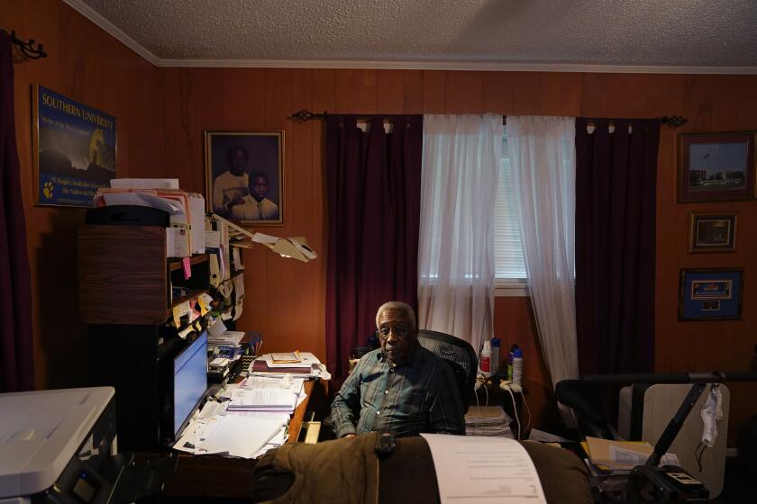 Press Robinson poses for a photo at his home in Baton Rouge, La., Wednesday, Aug. 24, 2022. When he registered to vote in 1963 he was handed a copy of the U.S. Constitution, told to read it aloud and interpret it. Robinson and activists say that Black voter voices and access to fair representation are once-again being restrained — this time, in the form of political boundaries fashioned by mainly white and Republican-dominated legislatures. (AP Photo/Gerald Herbert)