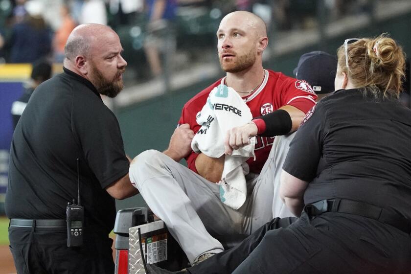 Los Angeles Angels' Jonathan Lucroy, center, is carted off the field after colliding with Houston Astros' Jake Marisnick at home plate during the eighth inning of a baseball game Sunday, July 7, 2019, in Houston. (AP Photo/David J. Phillip)