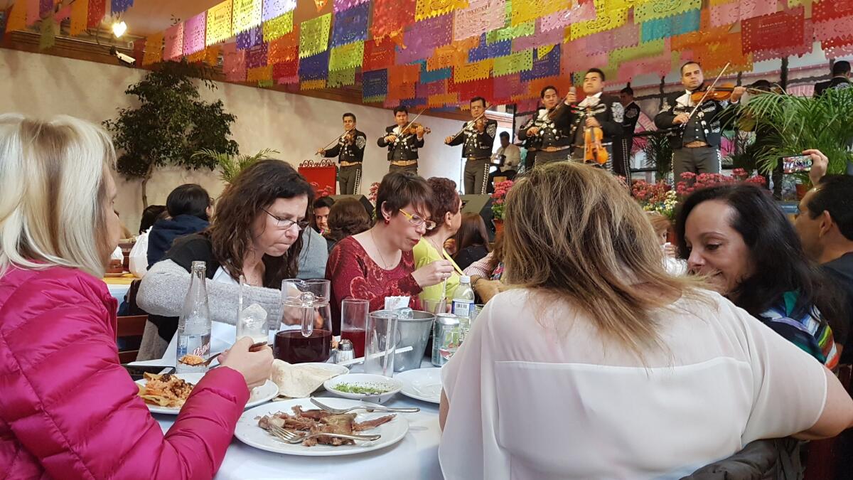 Diners eat lunch while a mariachi band plays at Arroyo Restaurant in Mexico City on Sunday.