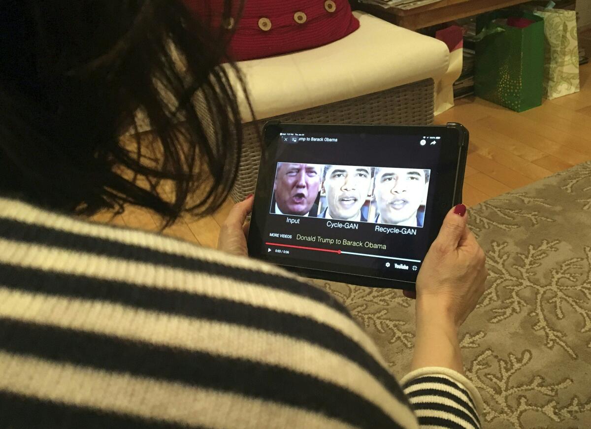 A woman views a manipulated video.