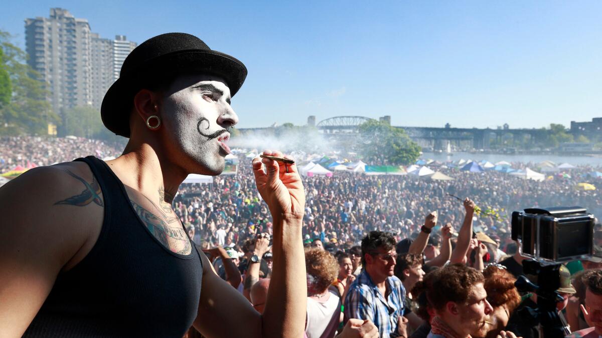 A man smokes during the 4/20 marijuana rally at Sunset Beach in Vancouver, Canada.