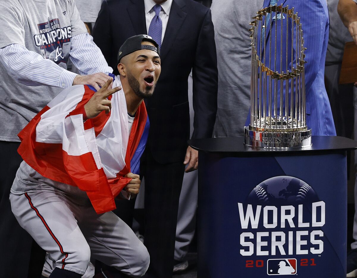 Atlanta Braves left fielder Eddie Rosario stands next to the trophy after the team's win in the World Series against the Houston Astros, Tuesday, Nov. 2, 2021, in Houston. (Kevin M. Cox/The Galveston County Daily News via AP)
