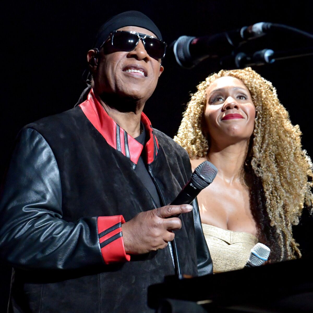 Stevie Wonder and daughter Aisha Morris onstage Sunday during Wonder's annual House Full of Toys benefit concert at Staples Center.