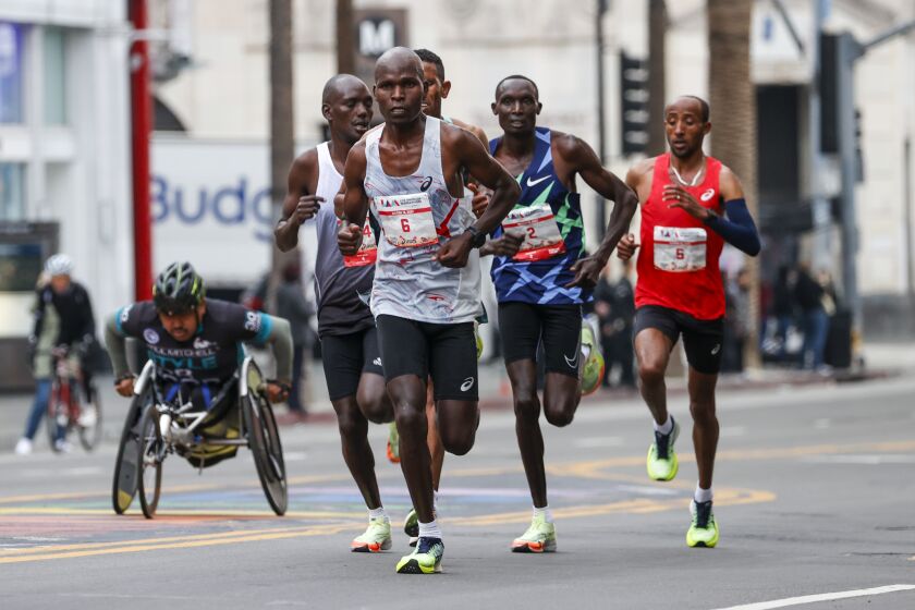 Men's elite runners run along Hollywood Blvd during the 38th LA Marathon in Los Angeles, Sunday, March 19, 2023. (Photo by Ringo Chiu / For The Times)
