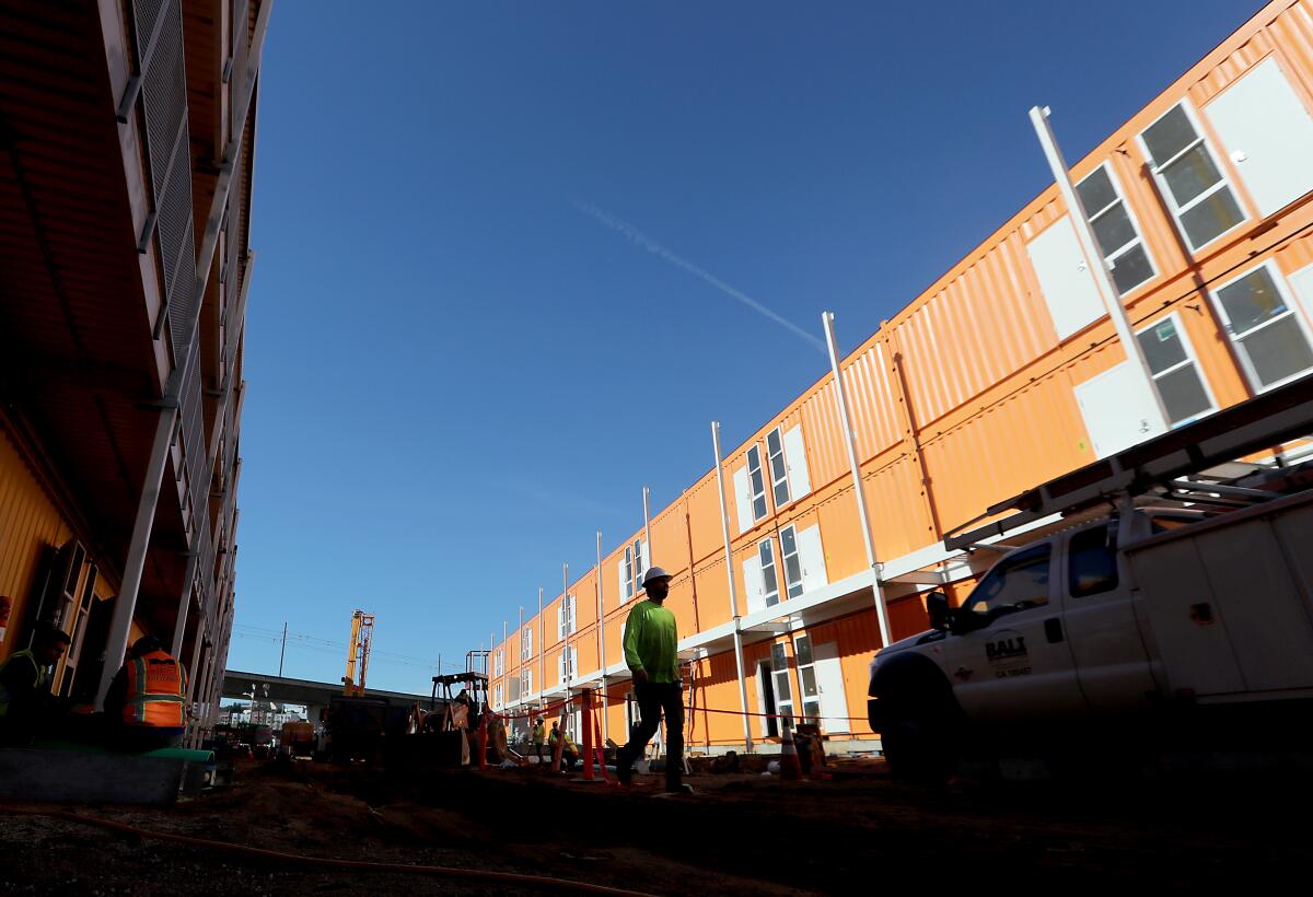 L.A. County contractors  completing a 232-unit homeless housing project in downtown Los Angeles.  