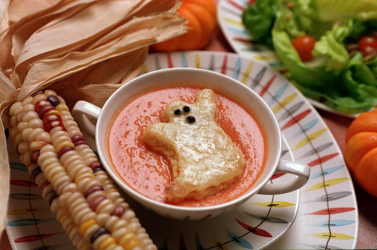 Tomato soup with ghost-shaped toast floating in it