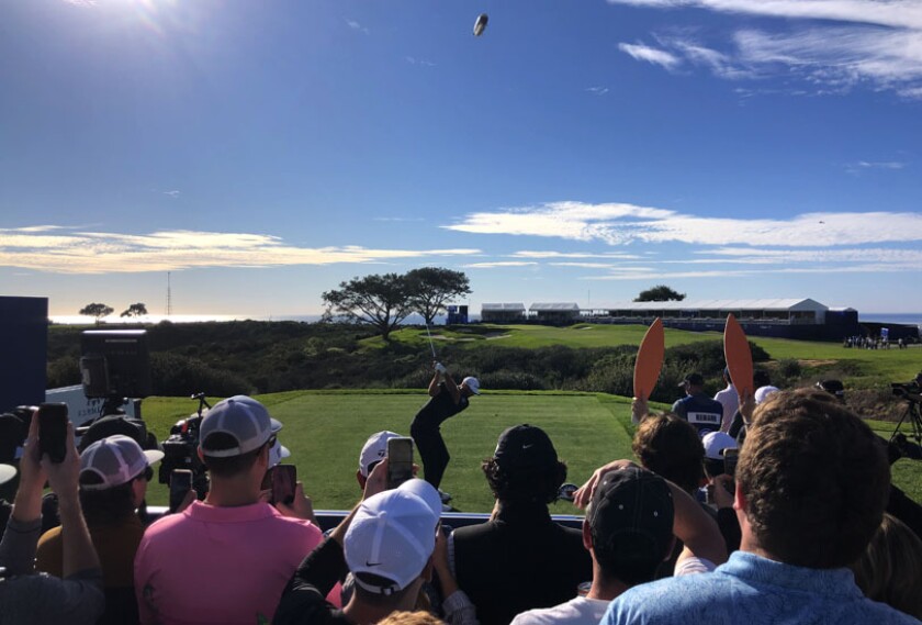 Spectators watch Dustin Johnson tee off on the South's 16th hole during Friday's third round of the Farmers Insurance Open.