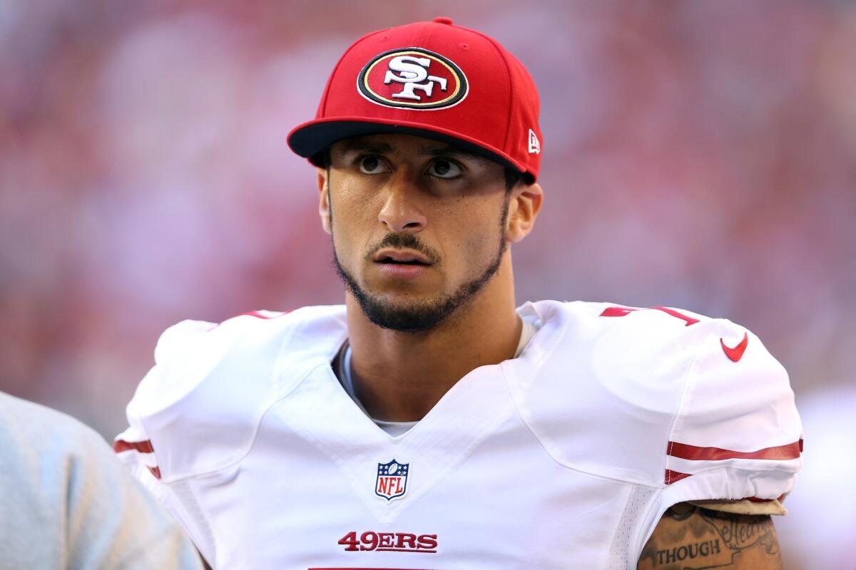 Colin Kaepernick looks on from the sideline during a game against the Arizona Cardinals.