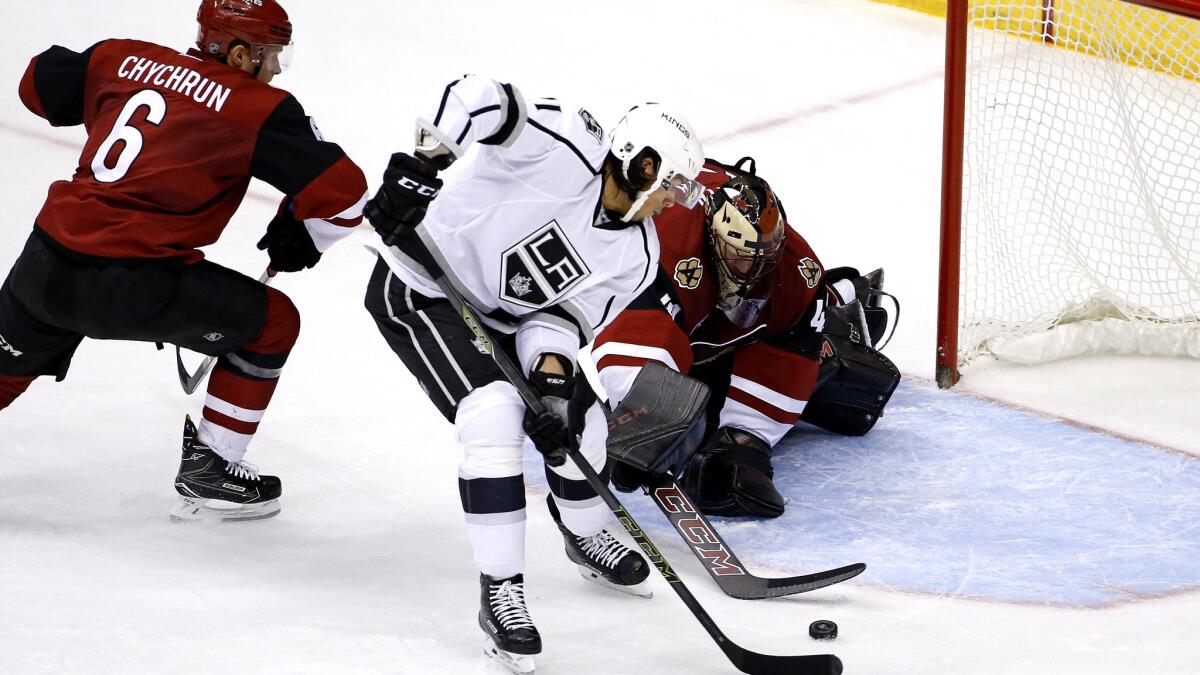 Kings forward Jordan Nolan beats Coyotes goalie Mike Smith defenseman Jakob Chychrun to the puck before scoring a goal during the second period Thursday night.