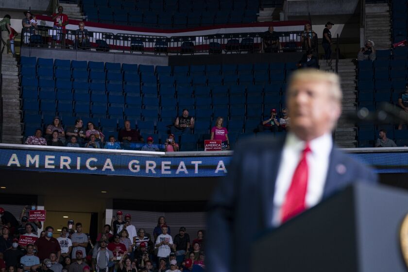 Supporters of President Donald Trump listen as he speaks to a campaign rally at the BOK Center, Saturday, June 20, 2020, in Tulsa, Okla. (AP Photo/Evan Vucci)